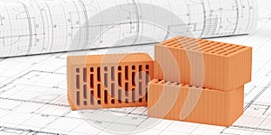Three red brick stones on architectural building construction plan background and drawing plan roll, construction or masonry or