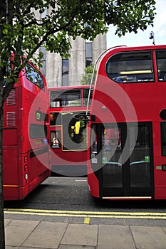 Three red buses in London