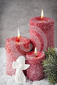 Three red candles on gray background, Christmas decoration. Advent mood.