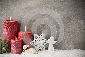 Three red candles on gray background, Christmas decoration. Advent mood.