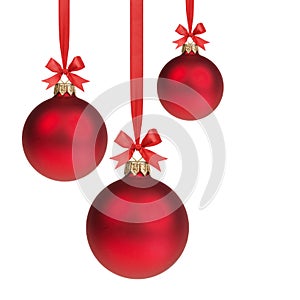 Three red christmas balls hanging on ribbon with bows