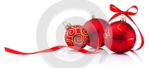 Three red Christmas baubles with ribbon bow isolated on white background