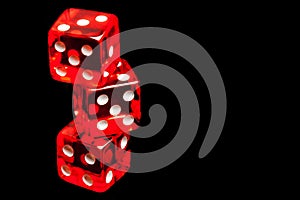 Three red dice on black background