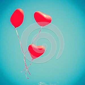 Three Red Heart-shaped balloons