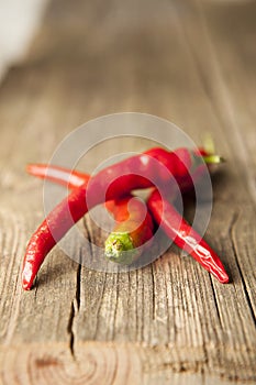 Three red hot chili peppers with green peppers