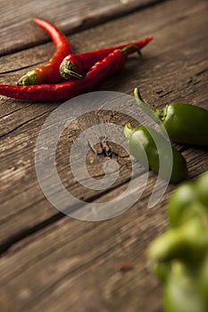 Three red hot chili peppers with green peppers