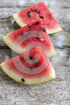 Watermelon pieces on the old board close up