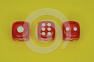 Three red plastic game cubes
