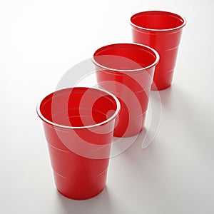 Three Red Plastic Party Cups Arranged in a Row on White Surface red cups plastic cups