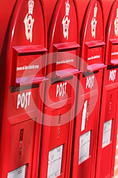 Three red post boxes