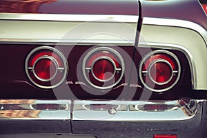 Three red rear tail lights from a vintage retro car with nostagic look