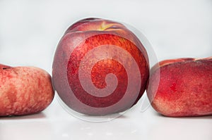 Compisition on white background with fruit. Peaches