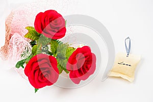 three red rose flower in bunch with love bag on white background