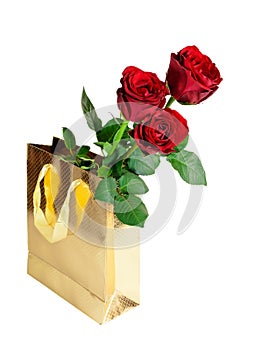 Three red roses in gift bag on white background