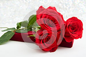 Three Red Roses and jewelery present box with boke Background. copy space - Valentines and 8 March Mother Women's Day concept