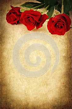 Three Red Roses over Grunge Background