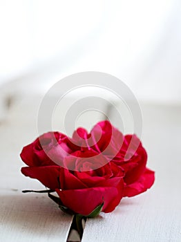 Three red roses on a vintage wooden crate