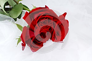 Three red roses on a white net - weddings