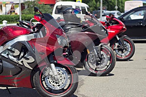 Three red sports motorcycles.