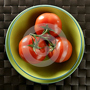 Three red tomatoes branch