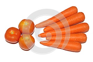 Three red tomatoes and five carrots against a white backdrop