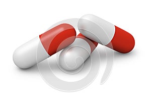 Three red and white capsules close up