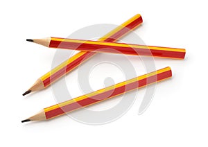 Three red and yellow graphite pencils