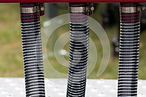 Three reinforced pipes on an agricultaral machine