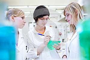 Three researchers/chemistry students in a lab