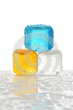 Three reusable plastic ice cubes with water