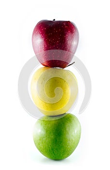 Three ripe colorful apples stacked as a trafficlight photo