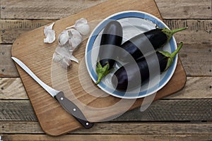 Three ripe eggplants on the plate