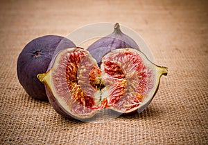 Three ripe figs from jute background