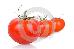 Three ripe isolated tomatoes