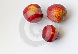 Three ripe nectarine fruits isolated on white background copy space. Healthy food