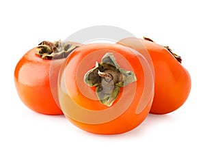 Three ripe persimmons on a white background. Isolated