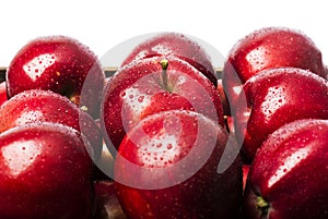 Three ripe red apples on a white background.