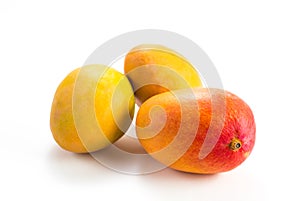 Three ripe tropical fruit mango isolated on white closeup