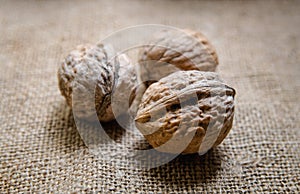 Three ripe walnuts lie on the table.