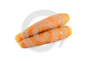 Three ripe washed fresh red carrots isolated on white closeup