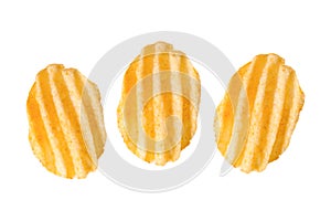 Three rippled potato chips on white