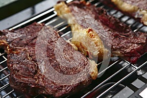 Three roast steak on electrical brazier photo