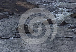 Three Rocks in the Tumult of a Frothing Stream