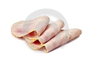 Three rolled slices of ham on a white background