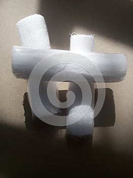 Three rolls of white gauze on a wooden table