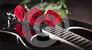 Three roses on black guitar