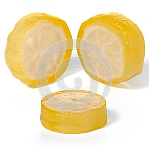 Three round fruit lemon caramels on a white