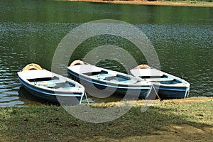 Three roving boats on lake side