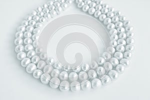 Three rows of natural pearl necklace on white