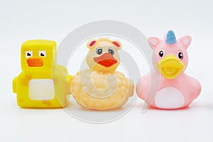 Three rubber ducks in a row isolated on a white background